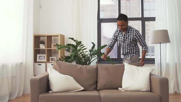 Indian Man Arranging Sofa Cushions at Home 105