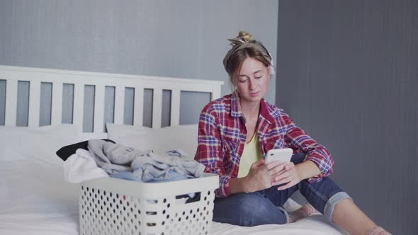 Beautiful Young Woman Is Resting on the Sofa After Doing Laundry