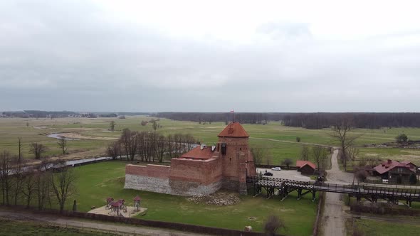 Aerial View of Liw Castle in Poland with a Flag