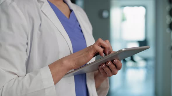 Caucasian female doctor using digital tablet in medical clinic. Shot with RED helium camera in 8K.