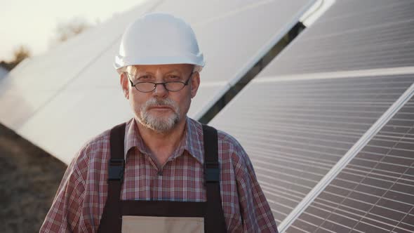 Portrait of Successful Engineer Stands at Solar Batteries with Crossed Hands