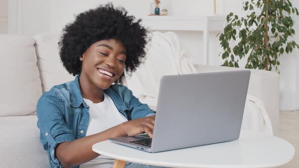 Happy African American Young Woman Do Remote Job From Home at Desk Smile Enjoy Telework Activity
