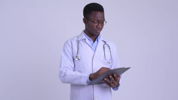 Young Happy African Man Doctor Holding Clipboard