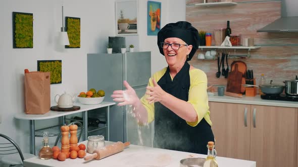 Elderly Baker Enjoying Cooking with Flour