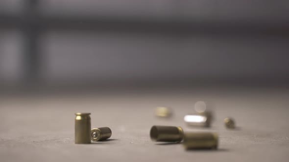 Multiple bullet shells falling to the ground and bouncing.