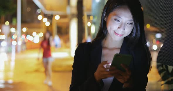 Business woman use of smart phone at night 