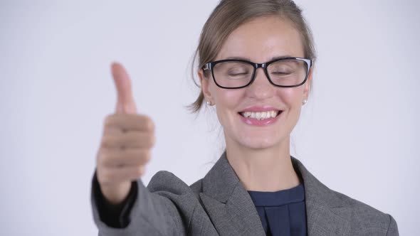 Face of Young Happy Businesswoman Giving Thumbs Up