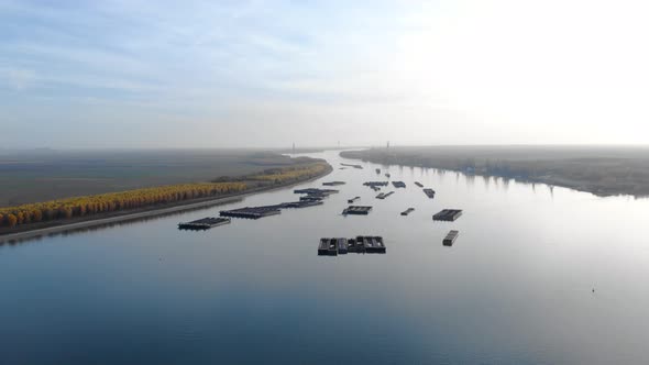 Aerial View Of Danube River With Floating Pontoons At Sunset In Galati, Romania. drone shot