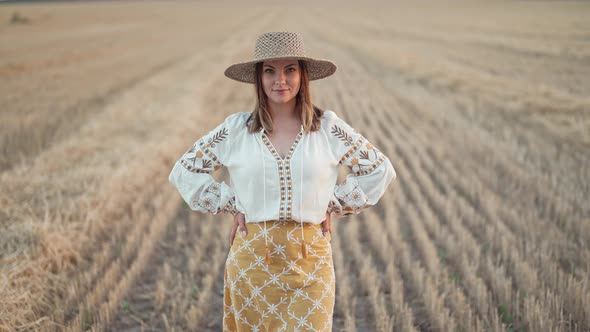 Smiling Ukrainian Woman in Wheat Field After Harvesting