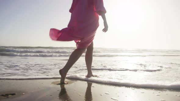 Woman in Beautiful Pink Waving Dress at Sunset Woman Feet Walking By Beach 6K