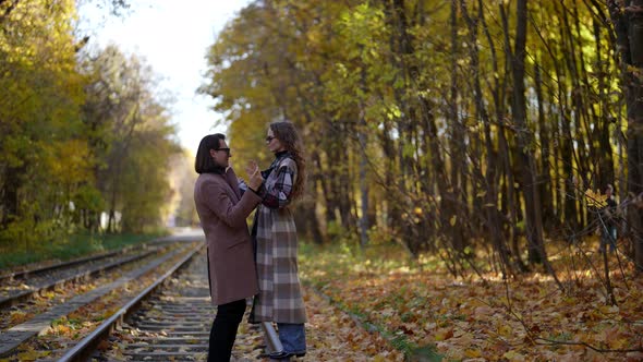 Loving Man and Woman are Walking Over Tram Rail in Autumn Day