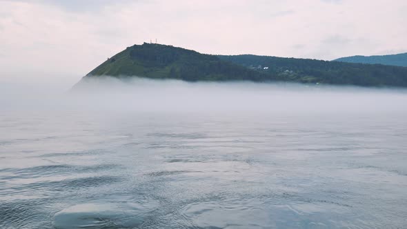 Lake Baikal in Russia in the Fog on the Background of the Mountain