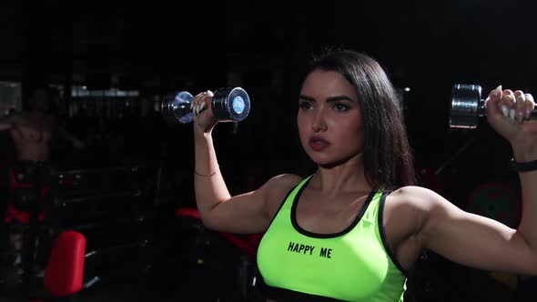 Gym Training  Sportive Woman Lifting Dumbbells and Training Her Hands