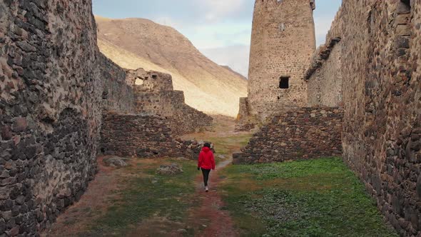 Tourist Walks Down Path Around Ruins