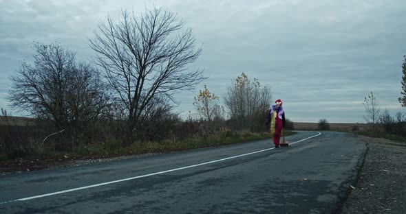 A Scary Clown Pulls A Hammer Down The Road