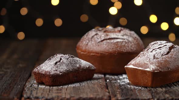 Three Christmas Breads Stollen Table on a Wooden Textured Table Against the Background of Blurred