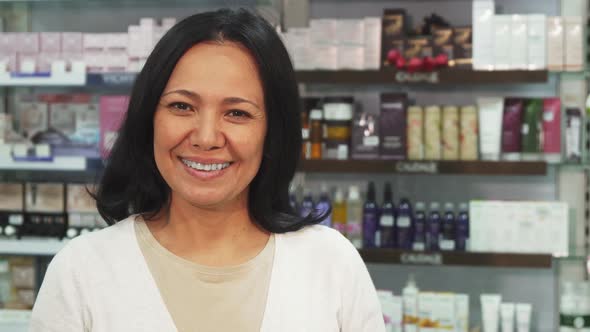 Happy Woman Showing Pills and Thumbs Up