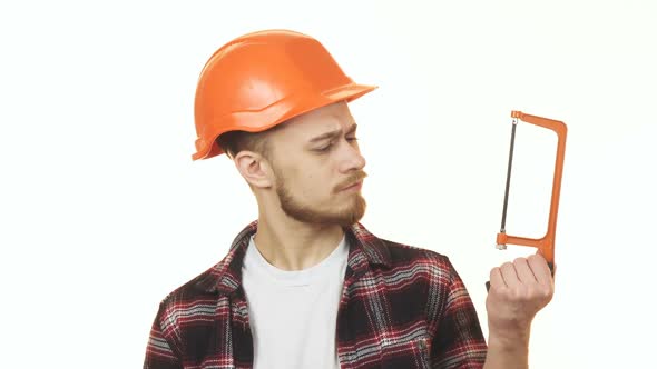 Young Handyman Choosing Between Two Saws To Use