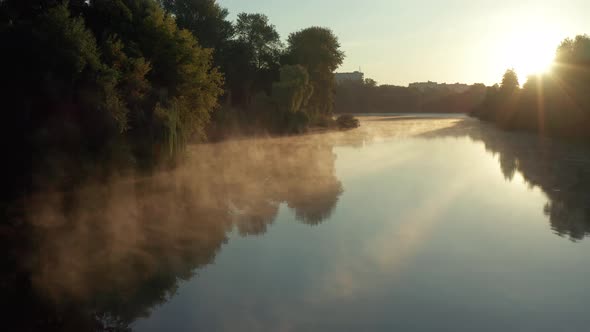 Beautiful morning, summer flight over the river. Fog, trees.