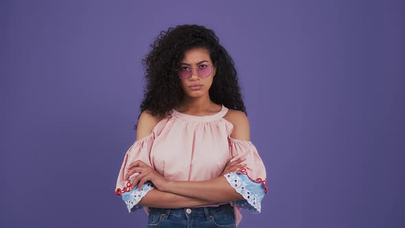 Ethnic Black Woman in Sunglasses Colorful Blouse and Jeans