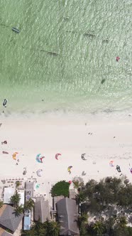 Vertical Video Kitesurfing Near the Shore of Zanzibar Tanzania