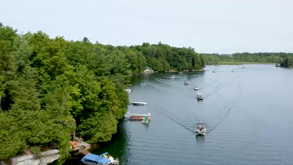 Aerial Drone Flight Above a Boat Parade on a Lake in the USA during the Summer
