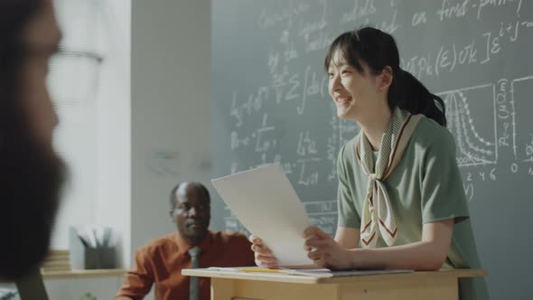 Cheerful Asian Girl Giving Presentation on College Lesson