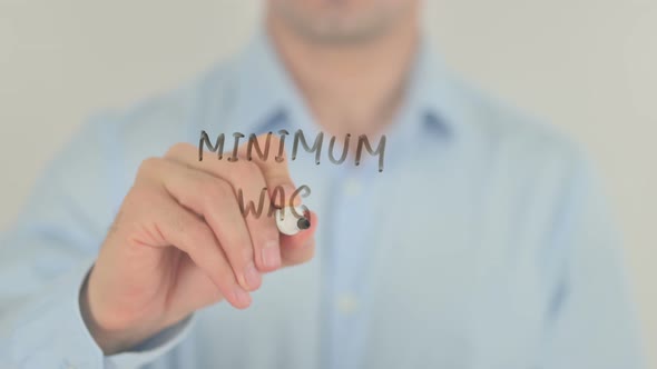 Minimum Wage, Man Writing on Transparent Glass Screen