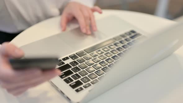 Woman Working on Smartphone and Laptop Top View