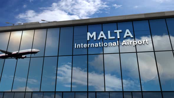 Airplane landing at Malta airport mirrored in terminal