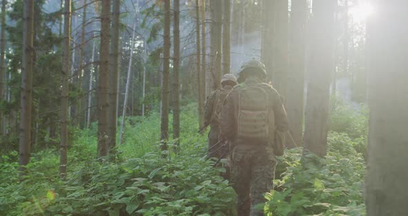 Millitary Operation with Gorup of Soliders Attacking Enemy Line in Dense Forest During Day Time