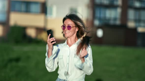 Beautiful Woman Having Good News Holding Smartphone Celebrating Success