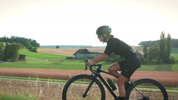 Woman cycling at sunset