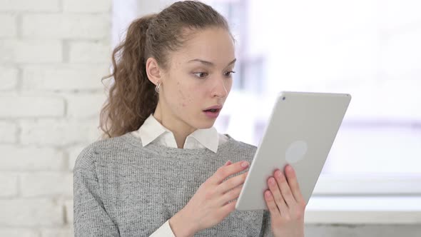 Portrait of Young Latin Woman Reacting To Failure on Tablet