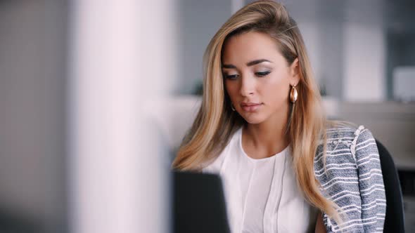 Happy Businesswoman Working on Her Laptop in the Office