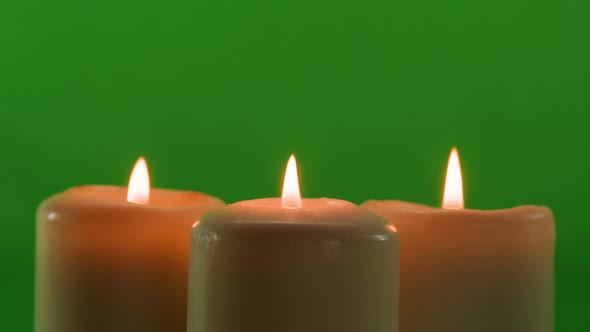Burning Wax Candles on Green Chroma Key Background