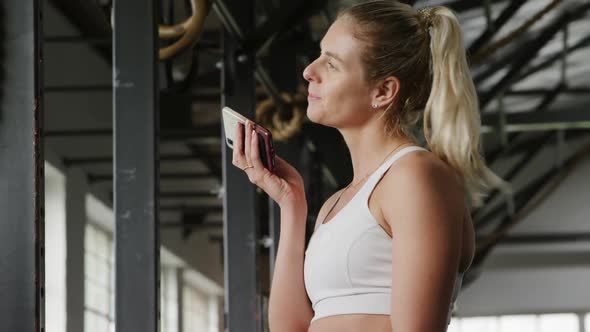 Side view athletic Caucasian woman talking on the phone