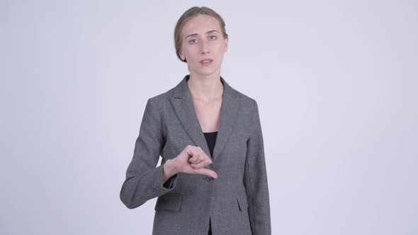 Young Stressed Blonde Businesswoman Giving Thumbs Down