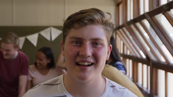 Portrait of teenage boy in school classroom