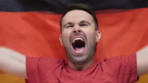 German Fan Celebrates Holding the Flag of Germany