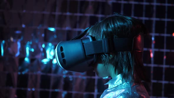 Boy Child in a Silver Shirt and Glasses Virtual Reality Playing a Game