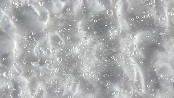 Motion Rotation of the Liquid Cream Gel Transparent Cosmetic Texture with Bubbles