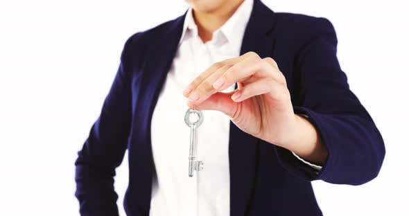 Mid-section of businesswoman holding a key