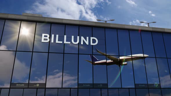 Airplane landing at Billund Denmark airport mirrored in terminal