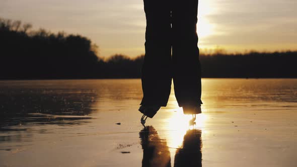 Cute Little Girl Is Going Skate Outdoors at Sunset. A Schoolgirl Enjoying Ice Skating at Frozen Lake