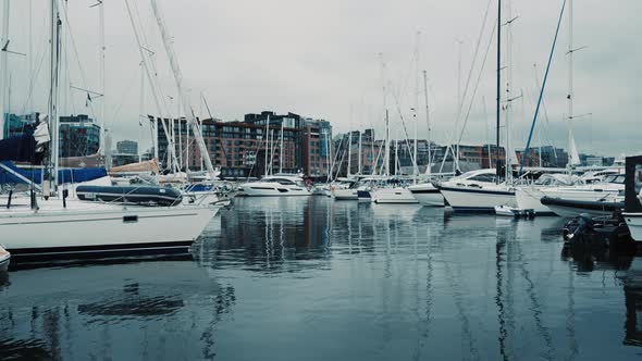 Blue Sailboat Moored to a Pier in Yacht Marina at Sunset