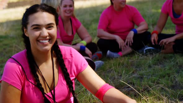 Portrait of female trainer relaxing during obstacle course