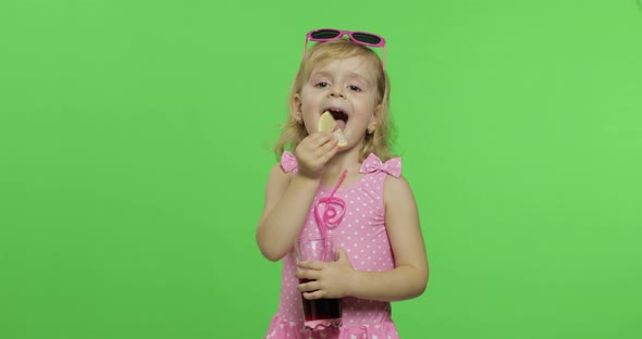 Child in Pink Swimsuit Drinks Juice Cocktail with Drinking Straw. Chroma Key