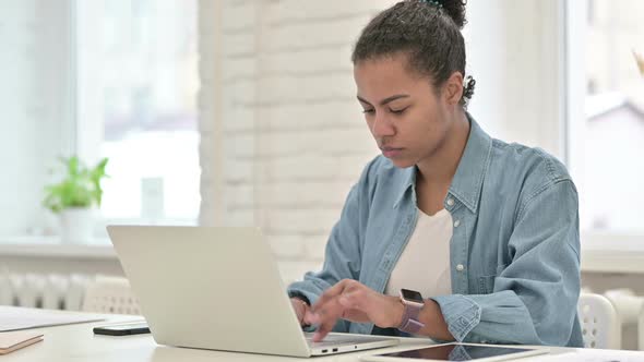 Young African Woman Working on Laptop