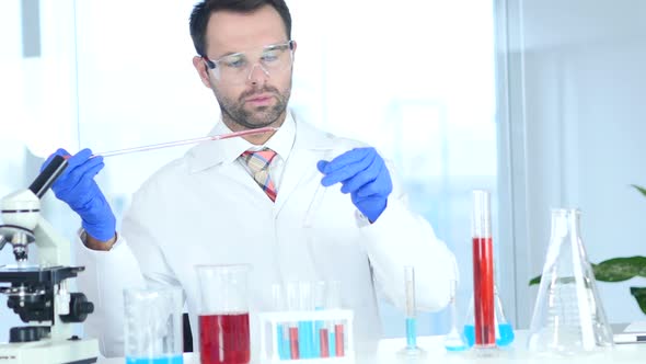 Scientist Busy Doing Chemical Reactions in Laboratory